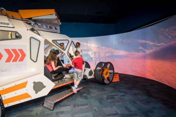 Children experiencing the Destination Mars Rover exhibit, looking at screen